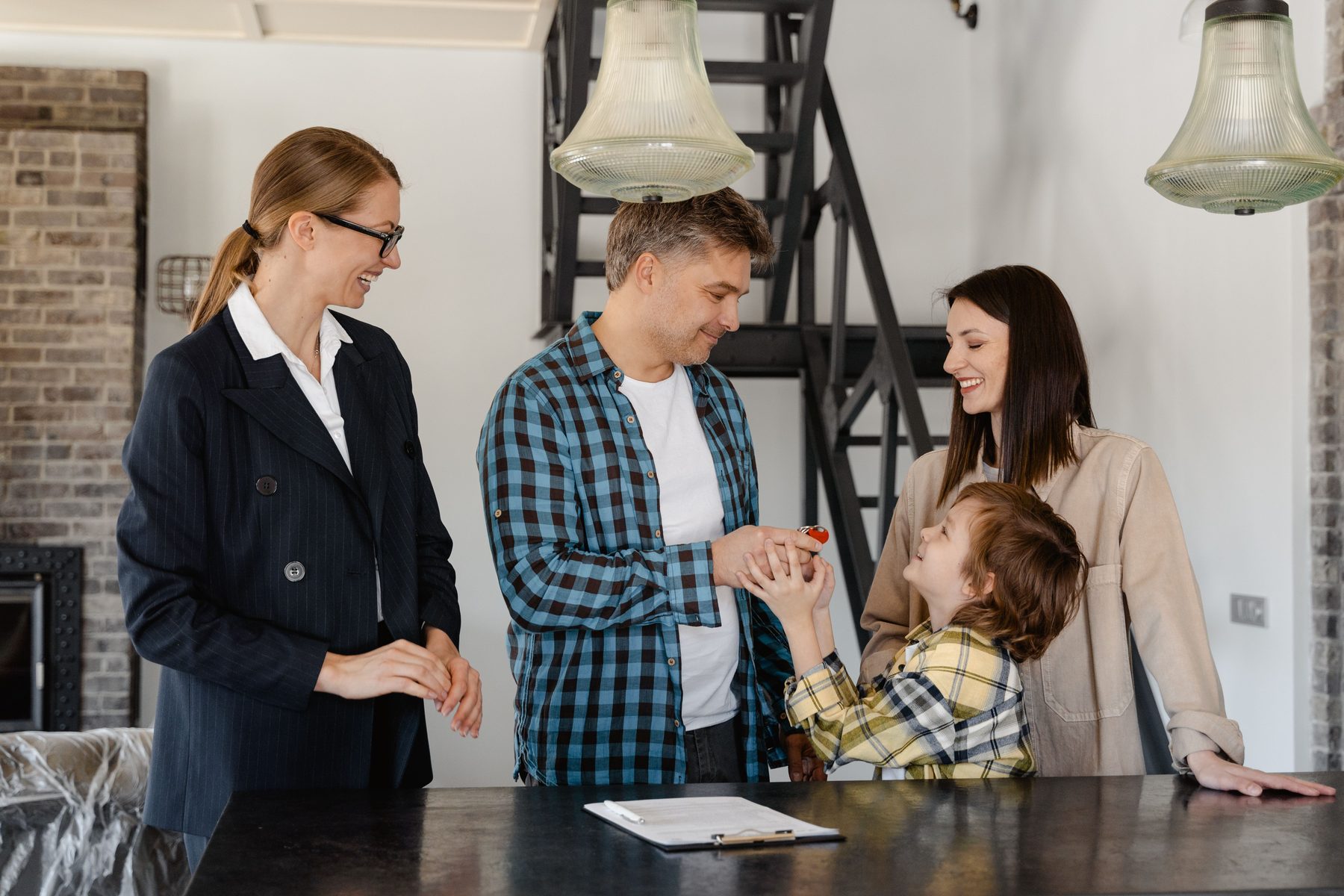 Family speaking with a real estate professional in a home