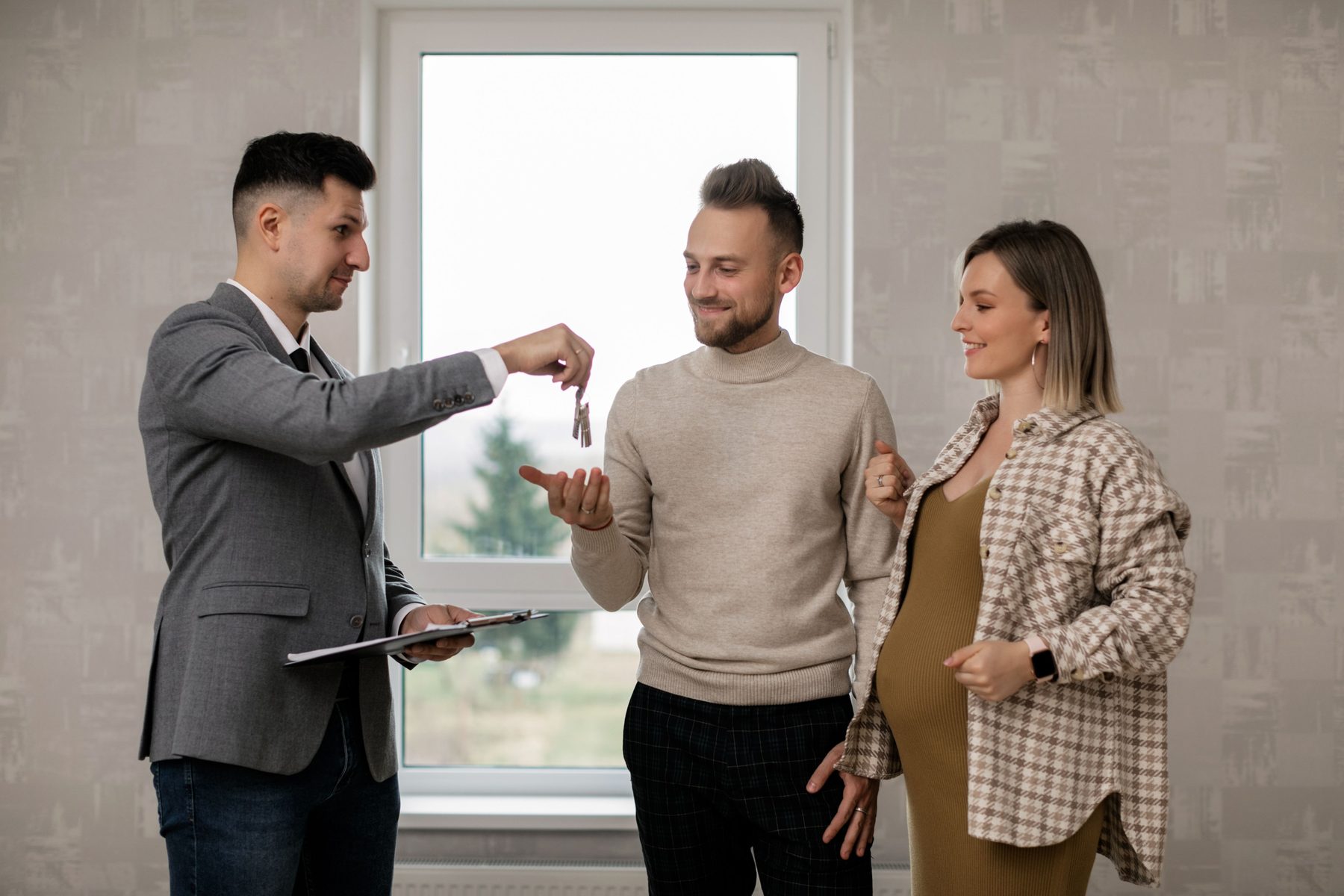 Homeowners receiving keys during a real estate transaction